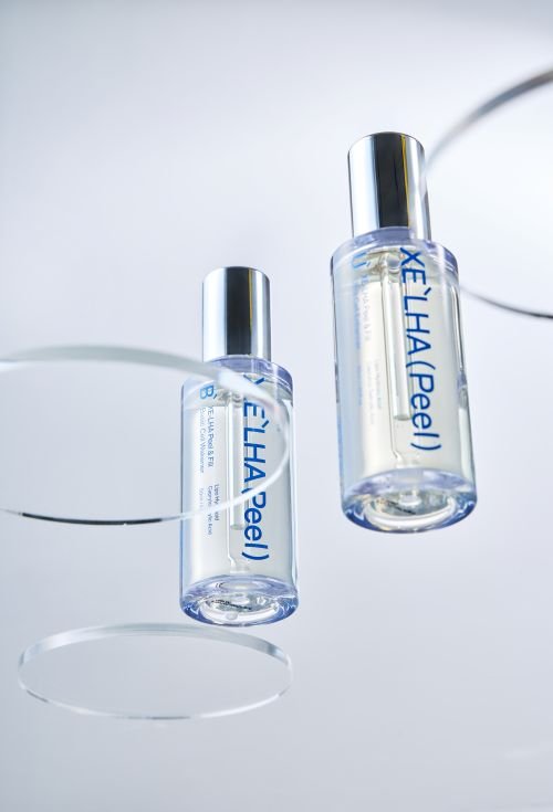 XE'LHA Peel bottles on a glass surface